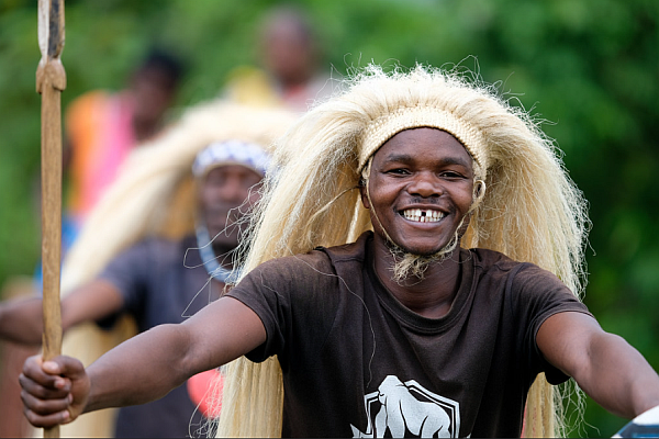 Joyful Rwandan dancer performing traditional dance in cultural attire, embodying vibrant local heritage.